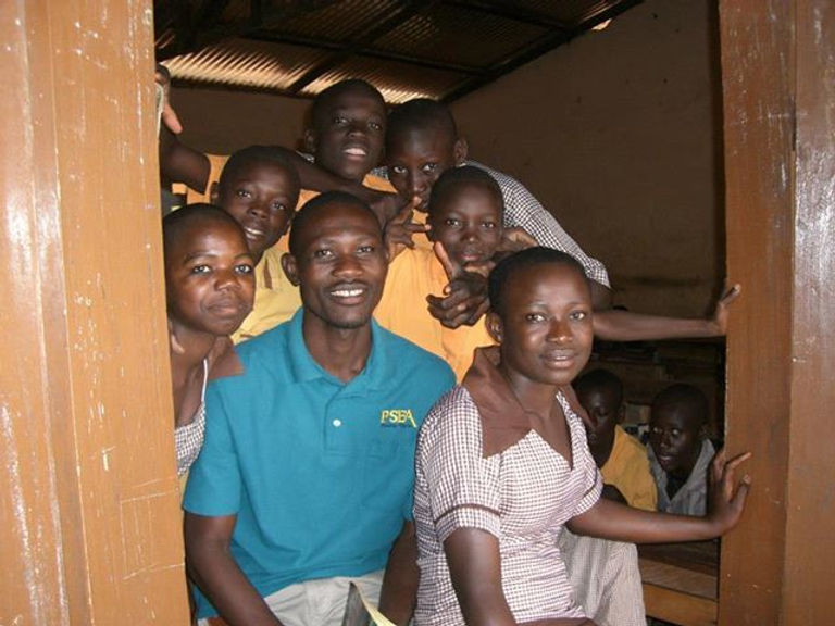 Girls and adults gathered in a doorway